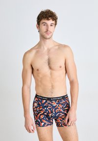 Boxer briefs in a navy base with a multicolored leaf pattern. Soft fabric with an elastic black waistband featuring "BJÖRN BORG" logo.