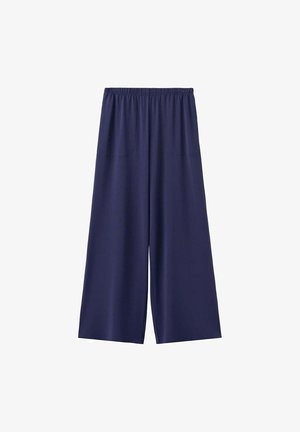 Pantalon large bleu marine avec taille élastique et poches avant, en tissu léger, adapté pour une tenue décontractée.