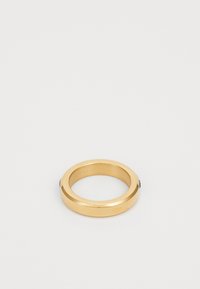 Gold metal ring with a smooth, polished surface. Circular shape with a slightly thicker band and a black accent detail.