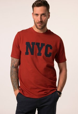 Red short-sleeve T-shirt made of textured fabric, featuring a prominent navy blue "NYC" graphic on the front. Casual fit, round neckline.