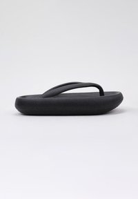 Black flip-flop with a textured footbed and smooth straps. Rounded sole edges. Minimalist design, featuring no additional accents or patterns.