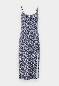 Marinblå blommig klänning med vita blommönster, spaghetti-stropper, rynkad front och en sidoklyvning. Tillverkad av lättviktigt material.