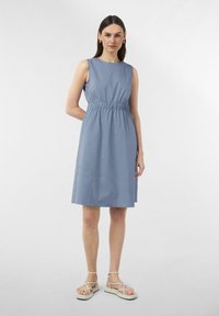 Helles blaues ärmelloses Kleid mit enganliegendem Oberteil und elastischem Bund. Glattes Baumwollgewebe, knielang, mit einer einfachen A-Linien-Silhouette.