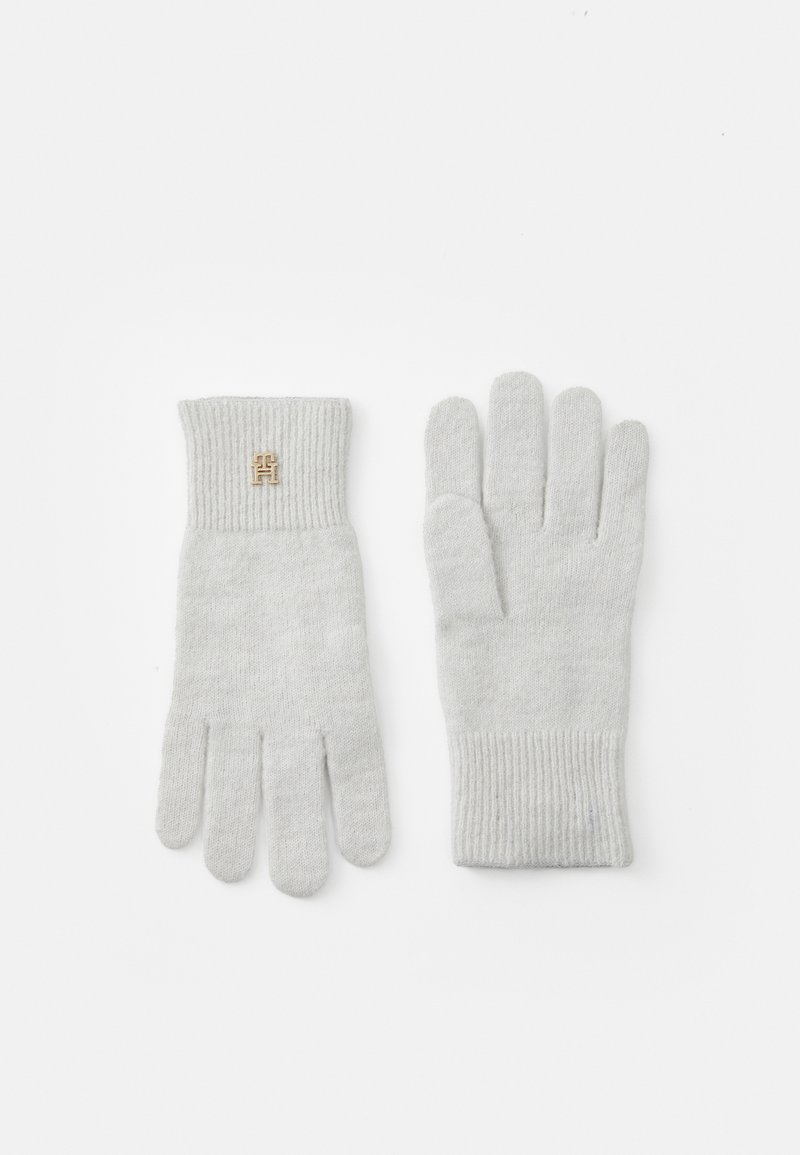 Grey knit gloves with a ribbed cuff, featuring a small gold emblem on the wrist area. Made of soft material, designed for warmth.