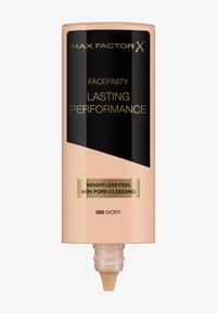 Fondotinta Max Factor Facefinity in avorio, tubo cilindrico beige con etichetta nera e accenti dorati, dotato di un beccuccio per la distribuzione.