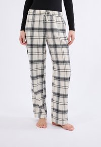 Pantalones de pijama a cuadros en crema con patrón de cuadros en negro y gris, con cinturilla elástica y cordón, fabricados en suave algodón.