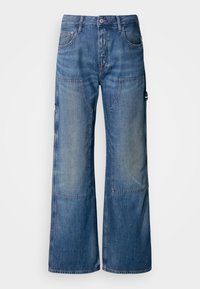 Wide-leg blue jeans made of denim, featuring a faded finish, multiple pockets, and a button-fly closure. Textured with visible stitching.