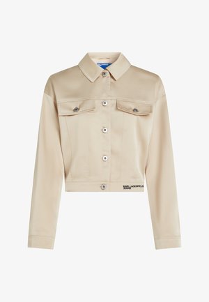 Krátká béžová bunda z hladké tkaniny, s špičatým límcem, knoflíky vpředu, dvěma náprsními kapsami a logem na lemu.