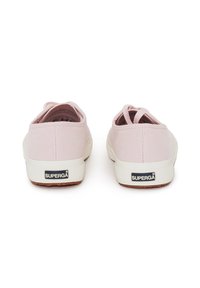 Scarpe in tela rosa con suole in gomma bianca, caratterizzate da un design testurizzato e un accento del logo sul retro. Stile slip-on con dettagli elasticizzati sul retro.