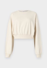 Skjært, beige sweatshirt med lange, puffermer. Har elastisk midje og ribbede mansjetter. Diskret logo brodert nær halslinningen.