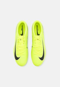 Bright yellow Nike Mercurial soccer shoes featuring a textured upper, black logo accents, and lace-up design.