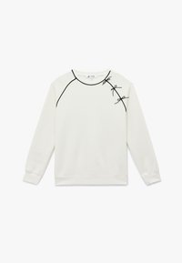 Kremowy sweatshirt z czarnymi wykończeniami i dekoracyjnymi kokardkami na lewym ramieniu. Posiada okrągły dekolt i długie rękawy. Miękka tekstura.