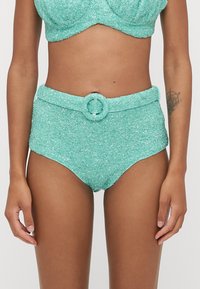 Turquoise high-waisted bikini with a textured, sparkly finish; features a waist belt with a circular buckle.