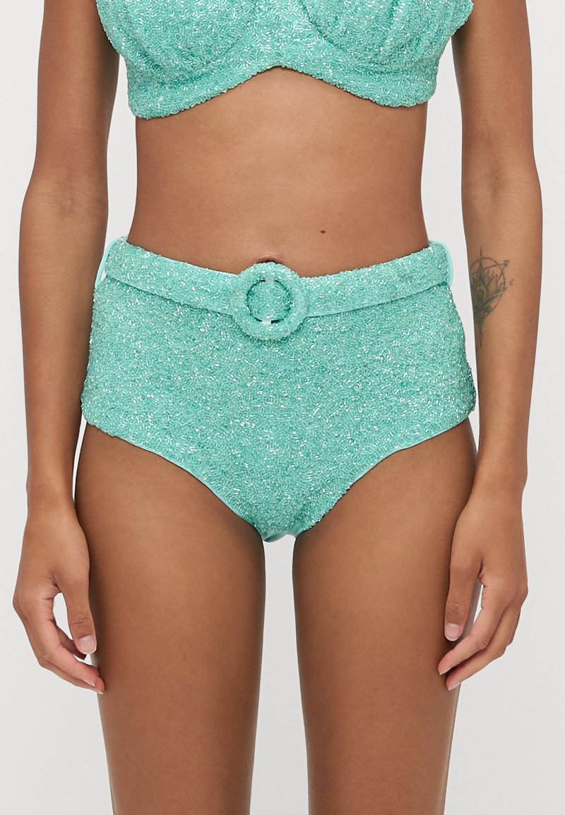 Turquoise high-waisted bikini with a textured, sparkly finish; features a waist belt with a circular buckle.