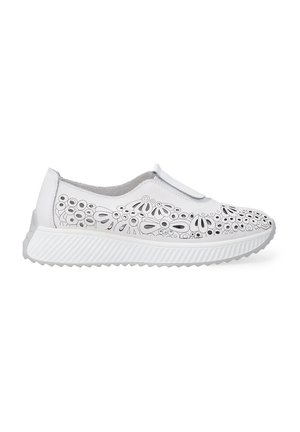 White slip-on shoe with a textured sole. Features laser-cut floral patterns along the upper and a smooth finish. Accented with subtle gray details.
