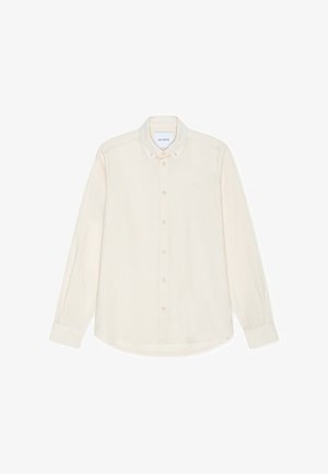 Langermet skjorte med knapper i lyst beige stoff. Har klassisk krage, seks knapper foran, og diskret merke på brystet.