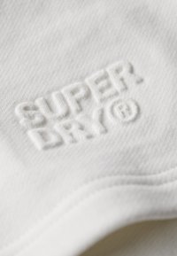 Superdry & Co EMBOSSED - Pantalon de survêtement - new chalk white