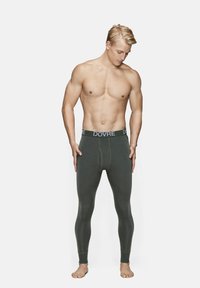 Grüne lange Unterwäsche mit einem elastischen Bund, beschriftet mit "DOVRE". Sie hat einen schmalen Schnitt und eine glatte Textur, die für Wärme und Komfort ausgelegt ist.