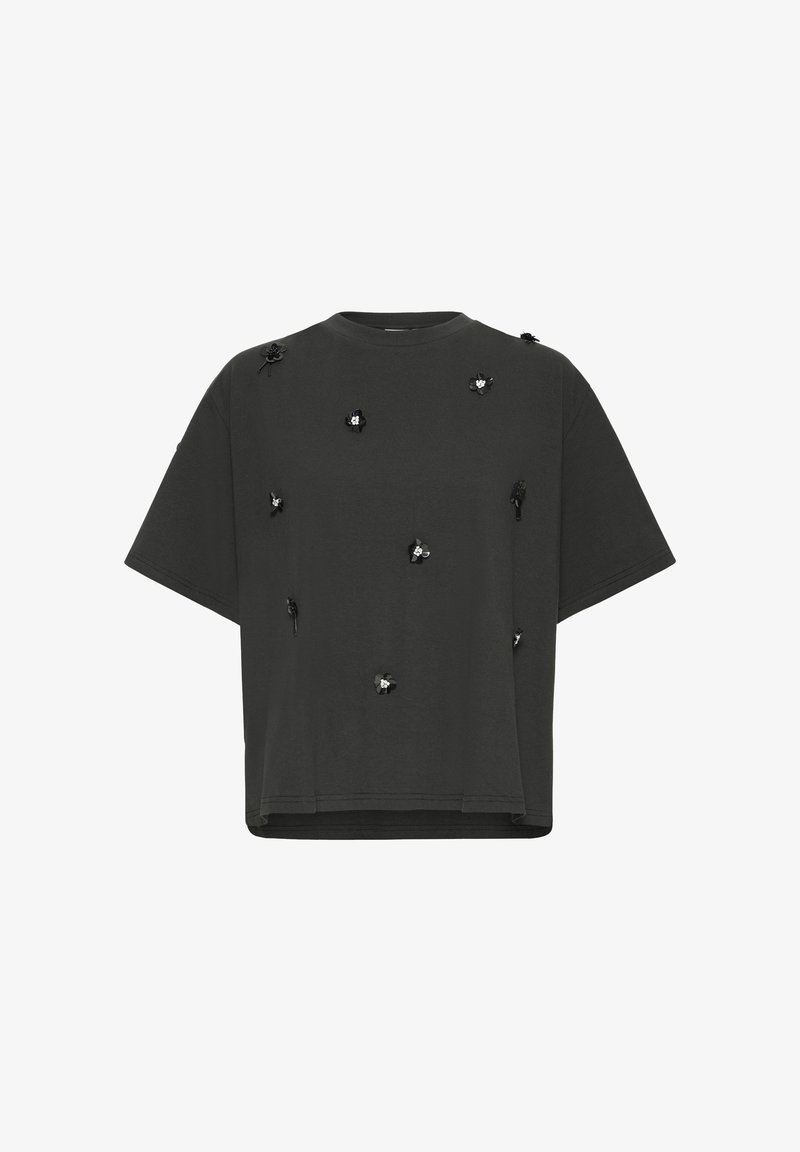 Black cotton t-shirt, short sleeves, oversized fit, featuring clustered floral embroidery accents with contrasting elements throughout.