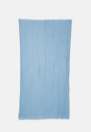 Tissu textured bleu clair, de forme rectangulaire avec des bords effilochés. La surface présente un motif subtil de froissement pour ajouter de l'intérêt visuel et tactile.