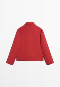 Red cropped jacket with a collar, long sleeves, and a pocket detail on the back. Smooth texture, casual fit, no visible fasteners.