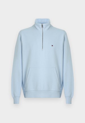 Felpa azzurro chiaro con zip a un quarto, collo alto, tasca frontale a marsupio, polsini e orlo a coste e piccolo logo Tommy Hilfiger sul petto.