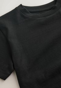 Black t-shirt with a round neckline and short sleeves. Fabric is smooth and unpatterned, featuring a subtle sheen. Edges are neatly stitched.