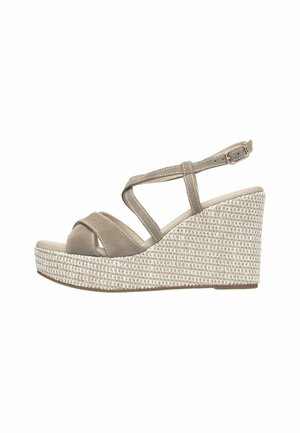 Beige wedge sandal with crisscrossed suede straps and an adjustable ankle buckle. The woven-textured platform offers stability and style.
