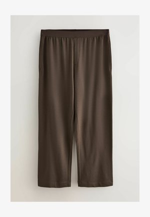 Pantalon marron, léger, longueur genou, avec une ceinture élastique et des poches latérales ; texture lisse avec une légère brillance.