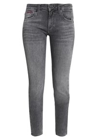 Vaqueros skinny de mezclilla gris con una cintura de altura media, cinco bolsillos, y cierre de botón y cremallera. Desgaste sutil y textura suave en toda la prenda.
