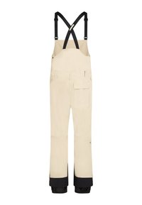 Pantalones de nieve beige con tirantes negros ajustables, puños de tobillo reforzados en negro, bolsillos laterales y un tejido texturizado para mayor durabilidad.