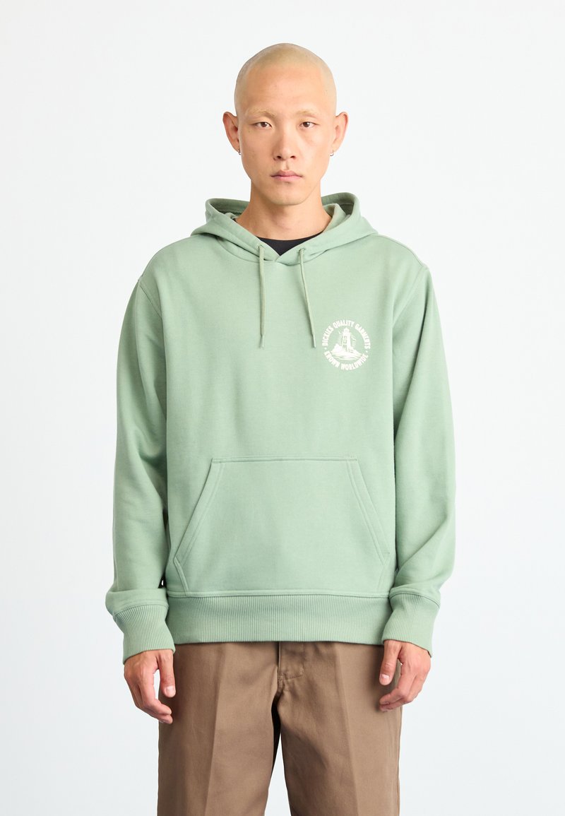 Light green hoodie made of cotton blend, featuring a front pocket, drawstring hood, and a circular logo on the chest. Relaxed fit.
