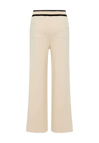 Pantaloni beige a gamba larga con vita elastica a strisce nere e due tasche posteriori. Tessuto morbido con un design a vestibilità rilassata.