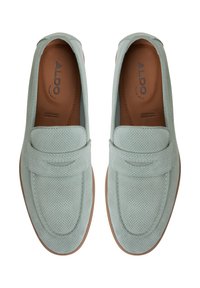 Light blue perforated leather loafers with a flat brown sole and a smooth toe. Features stitched accents and an embossed logo inside.