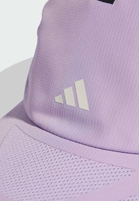 Lilac cap with textured, ribbed fabric. Features perforated accents and a white three-stripe logo. Sports design for active wear.