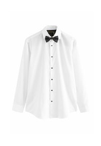 Chemise blanche en coton, à manches longues, dotée d'un nœud papillon noir et de boutons noirs sur le devant.