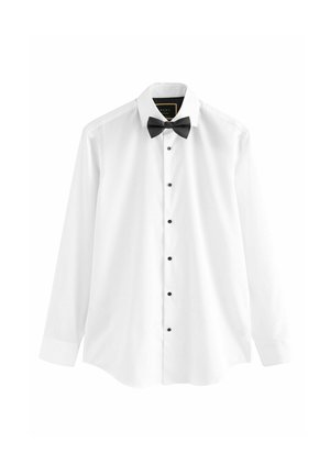 White dress shirt made of cotton, featuring long sleeves, a black bow tie, and black buttons down the front.