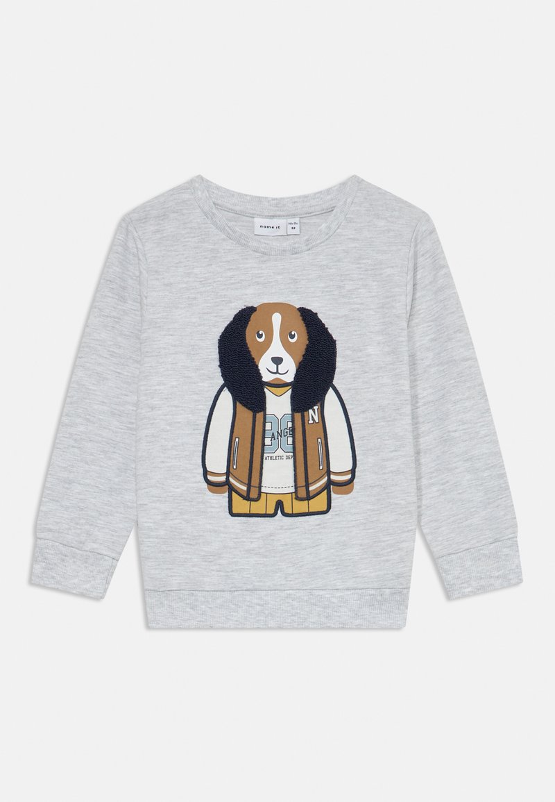 Sweatshirt gris avec un design de chien en cartoon ornée d'accents marron et blanc. Le chien porte une chemise crème et une veste marron avec des détails bleus.