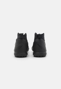 Black ankle-height sports shoes with a smooth, matte finish, featuring a textured heel tab and subtle branding along the side.