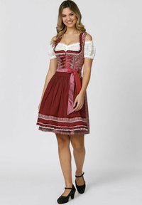 Traditional dirndl dress with a deep burgundy bodice, white lace sleeves, and a pleated skirt featuring a polka dot pattern and lace trim.