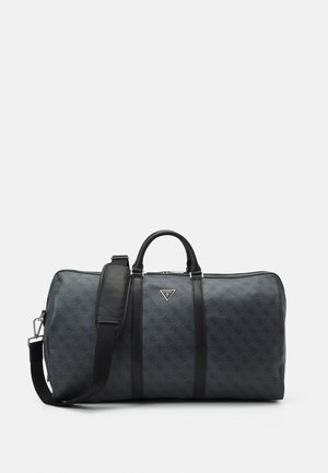 Sac de sport gris foncé à motif avec poignées noires et bandoulière réglable, avec un petit logo triangulaire au centre avant.