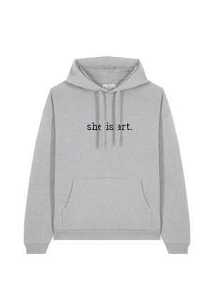 Haut à capuche gris en tissu doux avec une poche avant et un cordon de serrage. Le texte "elle est art." est affiché en noir de manière bien visible.