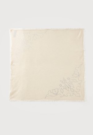 Tissu rectangulaire beige avec broderie florale subtile dans deux coins opposés et petites franges le long des bords.
