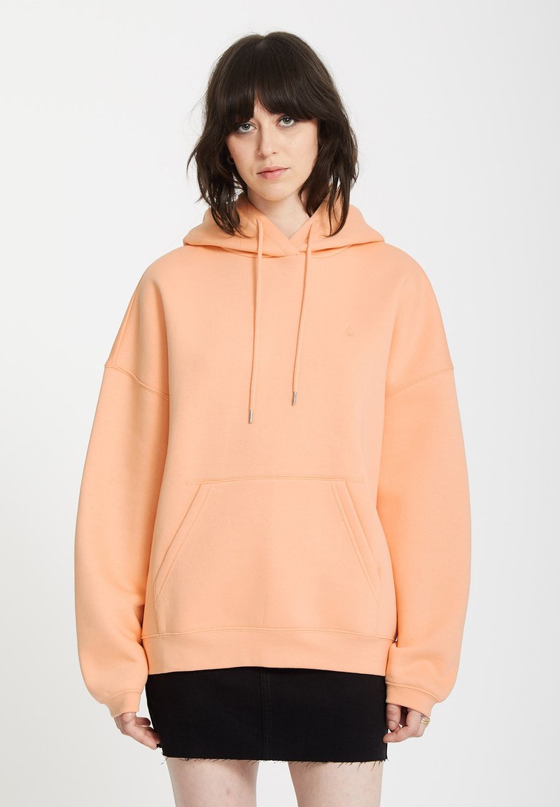 ferskenfarvet oversized hoodie med en frontlomme, snoretræk i huen og ribbede manchetter. Glat tekstur, minimalistisk design og diskret branding.