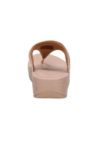 Lys beige plattform sandaler med en enkelt tårem, myk fotseng og en lett hæl. Glatt materiale, minimalistisk design og rund form.