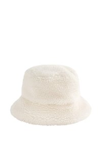 Krem-bijela kapa s širokim, fleksibilnim rubom i okruglim vrhom, napravljena od mekane, teksturirane flanele. Šavovi dodaju definiciju.