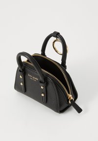 Black textured mini handbag with gold zipper, two handles, and a gold keyring, branded "kate spade NEW YORK" on front.