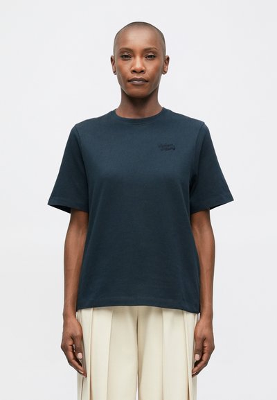 Dark blue cotton t-shirt with a round neckline, short sleeves, and minimal branding in a tonal embroidery. Slightly loose fit, smooth texture.