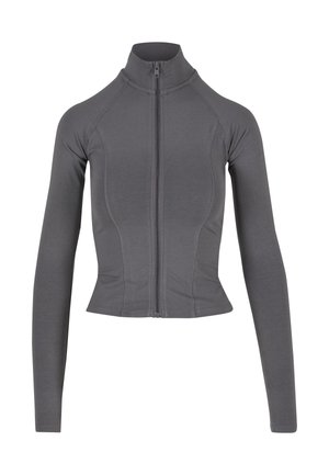 Veste grise ajustée en tissu extensible, avec un col montant et une fermeture éclair intégrale. Des coutures décoratives soulignent la forme du vêtement.