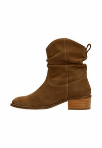 Brown suede ankle boots with a slouched shaft, rounded toe, and a chunky wooden heel. Visible stitching detail along the seams.